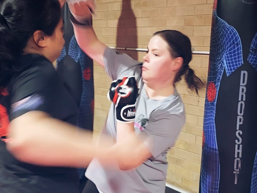 Women’s Only self defence: a member striking pads with her partner at Close Combat